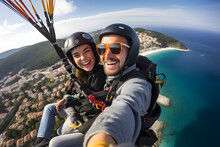 Couple Enjoying A Tandem Paragliding Experience Over A Coastal Town.