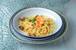 Spaghetti with seafood and parmesan on a blue background. Mediterranean Kitchen. Sea mood menu.