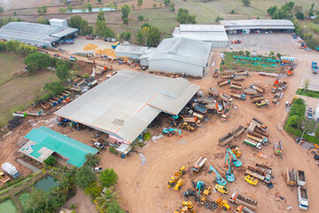 Wall Mural - Aerial view of tractor truck cars in industrial factory for construction site.