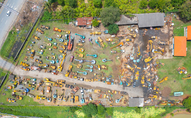 Wall Mural - Aerial view of tractor truck cars in industrial factory for construction site.