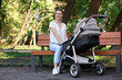 © New Africa - Happy nanny with baby in stroller in park