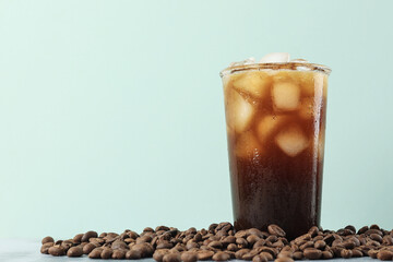 Wall Mural - Iced Americano Coffee with Coffee Beans on Light Background