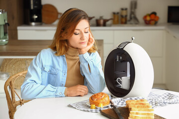 Canvas Print - Young woman with coffee machine in kitchen