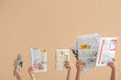 © Pixel-Shot - Female hands with different newspapers and microphone on color background