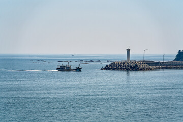 Small boats and lighthouses on the blue sea