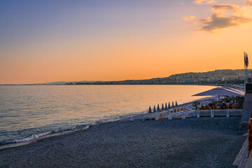 Wall Mural - Sunset at an empty Mediterranean Sea beach in Nice, South of France