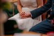 © aBSicht - Married couple hold their hands during the wedding ceremony
