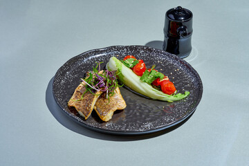 Wall Mural - Fried seabass fillet with vegetables in a plate