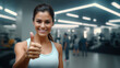 © Phoophinyo - A Smiling Woman, fitness and thumbs up to health, wellness and healthy lifestyle with gym.