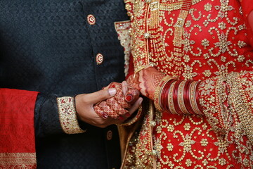 Wall Mural - henna on hands, groom holding hands bride holding hands , wedding photoshoot