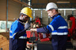 © offsuperphoto - factory workers or engineers giving wrench and tools from box in robot factory
