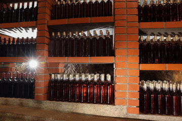 Wall Mural - Many bottles of wine stored on shelves in cellar