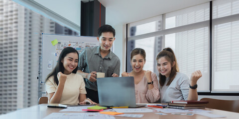 Wall Mural - group of designer cheerful giving high five on the success of website design and application on mobi
