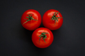Wall Mural - Three Red Tomatoes on black background