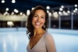 Portrait of a beautiful young woman on ice skating rink background.