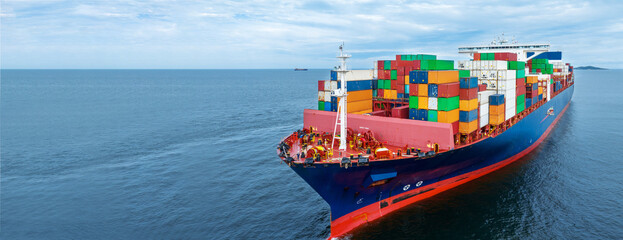 aerial side view of cargo container ship carrying container from custom container depot go to ocean 