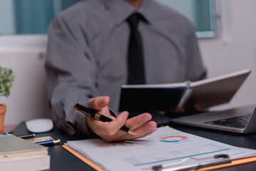 Businessman analyze data graph investment and chart accounting, report financial and marketing document development with laptop on desk.