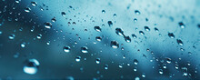 Water Or Oil Drops On Glass Surface In Blue Colors. Dropslet Close Up.
