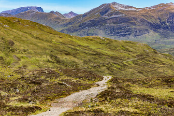 Sticker - A hiking trail heading towards spectacular mountains with traces of summer snow (Ben Nevis and range, Scotland)