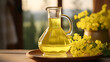 Rapeseed oil in a glass decanter and rapeseed flowers. Blurred background of the interior of a rustic house. Evening light.