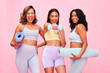 © Anela/peopleimages.com - Portrait, group and women with fitness, smile and pilates training on a pink studio background. Funny, girls and friends with exercise, self care and health with wellness, meditation and yoga mat