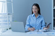 © Tj - Shot of a beautiful young financial assistant sitting in front of laptop and fill the form in the office.
