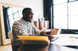 © BullRun - Aggressive African American man with laptop working on project