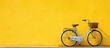 Fashionable bike next to a wall of yellow and white color