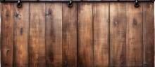 Closeup Of A Vintage Double Barn Door With Wooden Texture And Metallic Handle And Bolts Seen From The Front