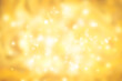 Golden rays and sparkles or glitter lights. Merry Christmas festive background. Defocused circle bokeh or particles