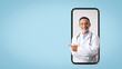 © Prostock-studio - Smiling caucasian senior doctor therapist in white coat point finger on free space on big phone screen
