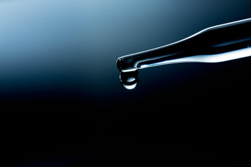Wall Mural - water droplets macro science experiment,liquid drop from laboratory glass pipette