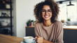 © Studio Nova - Beautiful woman smiling with a cup of coffee in the kitchen of her home