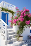 Fototapeta Na drzwi - Professional Shot of a Mediterranea House in Greece. Amazing Magenta Flowers creating this shot Captivating. 