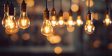 Hanging light bulbs on dark background. Cozy decoration indoor cafe or Christmas party vibe