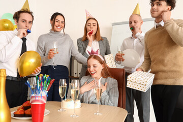 Group of young friends celebrating Birthday in office