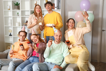 Wall Mural - Group of young friends celebrating Birthday at home