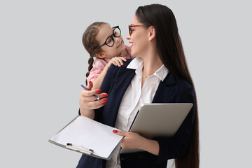 Poster - Little girl with her working mother on light background