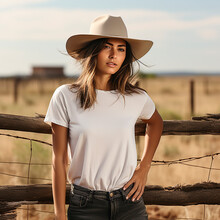 Woman In Cowboy Hat And White T-shirt Leaning Against Fence