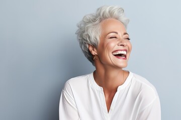 Wall Mural - Beautiful old woman with grey hair laughing and smiling.