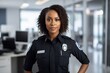 African American woman police officer standing in office.