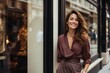 © Bargais - Smiling woman posing outside a luxury store.