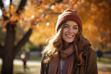 Wall Mural - Smiling woman in park at autumn.