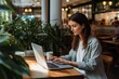 © Denis - Focused Woman Working on Laptop in Cozy Coffee Shop