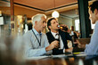 © Marko Geber - Diverse group of businessmen relaxing and having a beer after work in a bar