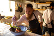 © Marko Geber - Young caucasian chef preparing a delicacy dish in a japanese style restaurant and diligently decorating the plate
