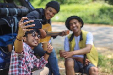 Friends on car road trip taking selfie