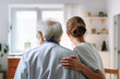 © PixMarket - Back view of a nurse with elderly man at home