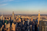 Fototapeta  - Captivating aerial view of New York City skyline during the dusk seen from The Edge. The buildings are shimmering with sunset colors. Endless rows of tall buildings. Bustling city. Endless horizon