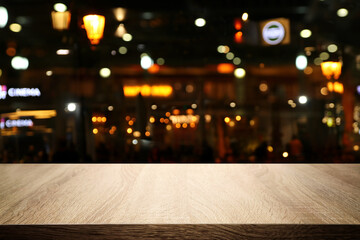 Wall Mural - background Image of wooden table in front of abstract blurred restaurant lights